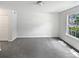 The room offers a spacious layout, neutral walls, plush carpeting, and a window providing views of the surrounding neighborhood at 9121 Charminster Ct, Charlotte, NC 28269