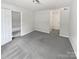 Comfortable bedroom with neutral carpet, ample space, and a closet with doors leading to additional rooms at 9121 Charminster Ct, Charlotte, NC 28269