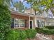 Charming two-story home features a brick facade, complemented by lush landscaping and a welcoming front entrance at 9121 Charminster Ct, Charlotte, NC 28269