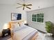 The main bedroom offers a comfortable retreat with a large window overlooking lush greenery, providing natural light and tranquility at 9121 Charminster Ct, Charlotte, NC 28269
