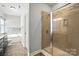 Bathroom showcasing a walk-in shower, bathtub, and modern tile work at 1006 Spring Rose Ln, Matthews, NC 28104