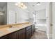 Bathroom featuring double sinks, a granite countertop, and a separate tub and shower at 1006 Spring Rose Ln, Matthews, NC 28104