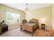 Cozy bedroom with a wicker bed, plush carpet, natural light, and simple yet elegant decor at 1006 Spring Rose Ln, Matthews, NC 28104