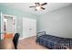 Neutral bedroom featuring a black bed frame, ceiling fan, closet, and neutral carpet at 1006 Spring Rose Ln, Matthews, NC 28104