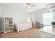 Bright bedroom with neutral carpet and a modern iron bed frame, illuminated by natural light at 1006 Spring Rose Ln, Matthews, NC 28104