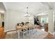 Bright dining room with modern chandelier and an inviting table setting at 1006 Spring Rose Ln, Matthews, NC 28104