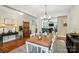 Bright dining room with wooden table, decorative chandelier, hardwood floors, and modern decor at 1006 Spring Rose Ln, Matthews, NC 28104