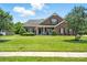 Inviting brick home with a green lawn, covered porch and decorative shutters at 1006 Spring Rose Ln, Matthews, NC 28104