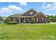 Charming brick home with a manicured lawn and inviting front porch at 1006 Spring Rose Ln, Matthews, NC 28104
