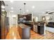 Open kitchen with stainless steel appliances, granite countertops, a kitchen island, and wood floors at 1006 Spring Rose Ln, Matthews, NC 28104