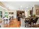 Kitchen with granite countertops, stainless steel appliances, island with seating, and hardwood floors at 1006 Spring Rose Ln, Matthews, NC 28104