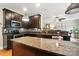 Kitchen with stainless steel appliances, granite countertops, kitchen island, and hardwood floors at 1006 Spring Rose Ln, Matthews, NC 28104