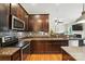 Kitchen with stainless steel appliances, mosaic backsplash, granite countertops, and wooden cabinets at 1006 Spring Rose Ln, Matthews, NC 28104