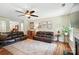Inviting living room with hardwood floors, ceiling fan, comfortable seating, and a cozy atmosphere at 1006 Spring Rose Ln, Matthews, NC 28104