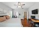 Large main bedroom with hardwood floors, ceiling fan, with a connected office and ensuite bathroom at 1006 Spring Rose Ln, Matthews, NC 28104