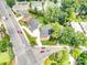 An aerial view showcases the neighborhood homes alongside lush greenery and a well-trafficked road at 101 Mcalway Rd, Charlotte, NC 28211