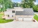 Aerial view of home showcasing a brick exterior, paved driveway, and a two-car garage at 101 Mcalway Rd, Charlotte, NC 28211