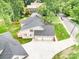 Aerial view of home showcasing a brick exterior, paved driveway, and a two-car garage at 101 Mcalway Rd, Charlotte, NC 28211