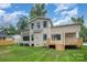 Back exterior view of home featuring a brick facade, lush lawn, and a wooden deck at 101 Mcalway Rd, Charlotte, NC 28211