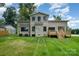 Back exterior view of home featuring a brick facade, lush lawn, and a wooden deck at 101 Mcalway Rd, Charlotte, NC 28211