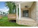 Inviting back porch with brick accents, ceiling fan, and sliding glass door access at 101 Mcalway Rd, Charlotte, NC 28211
