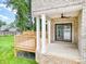 Inviting back porch with brick accents, ceiling fan, and sliding glass door access at 101 Mcalway Rd, Charlotte, NC 28211