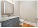 Bathroom featuring a granite countertop vanity, toilet, and hardwood flooring at 101 Mcalway Rd, Charlotte, NC 28211