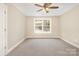 This comfortable bedroom is bathed in natural light with a ceiling fan and view of the backyard at 101 Mcalway Rd, Charlotte, NC 28211