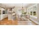 Bright dining room features hardwood floors, modern chandelier, and views into the kitchen at 101 Mcalway Rd, Charlotte, NC 28211