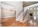 Elegant entryway boasting hardwood floors, staircase with iron railings, and views into the dining and living areas at 101 Mcalway Rd, Charlotte, NC 28211
