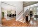 Elegant entryway boasting hardwood floors, staircase with iron railings, and views into the dining and living areas at 101 Mcalway Rd, Charlotte, NC 28211