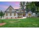 Beautiful two-story home featuring a manicured lawn, complemented by a stylish brick facade and a welcoming entryway at 101 Mcalway Rd, Charlotte, NC 28211