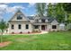 Beautiful two-story home featuring a manicured lawn, complemented by a stylish brick facade and a welcoming entryway at 101 Mcalway Rd, Charlotte, NC 28211