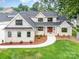 Front exterior view of the home featuring a well-manicured lawn and a red front door at 101 Mcalway Rd, Charlotte, NC 28211
