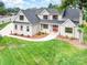 Eye-catching front exterior view of home with brick, a red front door, and a lush lawn at 101 Mcalway Rd, Charlotte, NC 28211
