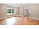 Inviting living room with a large window and hardwood floors, leading to a stylish glass-paneled front door at 101 Mcalway Rd, Charlotte, NC 28211