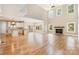 Open living space featuring hardwood flooring, a fireplace, and an open kitchen at 101 Mcalway Rd, Charlotte, NC 28211