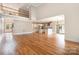 Open living space with hardwood flooring and kitchen in background at 101 Mcalway Rd, Charlotte, NC 28211