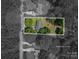 Aerial view of a home in a wooded area, with approximate property lines demarcated for clarity at 108 Graham St, Stanley, NC 28164