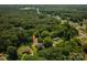 Aerial view of a home nestled among mature trees in a suburban setting, with neighboring houses visible at 108 Graham St, Stanley, NC 28164