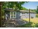 Backyard featuring a concrete patio, grey siding, brick accents, and a grassy lawn at 108 Graham St, Stanley, NC 28164