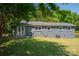Exterior of the house with concrete patio, well-maintained grass, and lush green trees at 108 Graham St, Stanley, NC 28164