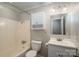 Bathroom with toilet, shower/tub, sink, mirrored medicine cabinet and overhead lighting at 108 Graham St, Stanley, NC 28164