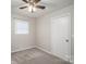 Bedroom with neutral walls, carpet floors, a window and white closet door at 108 Graham St, Stanley, NC 28164