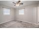 Bright bedroom features neutral walls, carpet floors, ceiling fan and natural light from two windows at 108 Graham St, Stanley, NC 28164