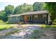 Charming single-story home with a welcoming front porch, well-kept landscaping, and a gravel driveway at 108 Graham St, Stanley, NC 28164