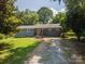 Inviting single-story home with a gray facade, complemented by a well-manicured lawn and driveway at 108 Graham St, Stanley, NC 28164