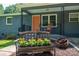 Inviting front porch featuring a cozy rocking chair and a decorative bench with planted flowers at 108 Graham St, Stanley, NC 28164
