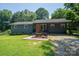Charming single-story home with a well-maintained lawn, inviting walkway, and quaint front porch at 108 Graham St, Stanley, NC 28164