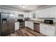 The spacious kitchen features stainless steel appliances, granite countertops and ample cabinet space at 108 Graham St, Stanley, NC 28164